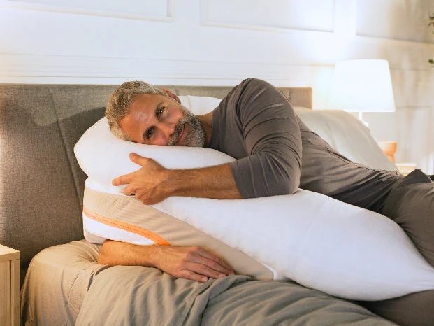 Man sleeping on his side on the MedCline Reflux Relief System